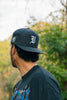 "V" LOGO EMBROIDERED SNAPBACK HAT
